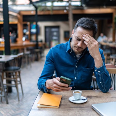 Frustrated man reading texts