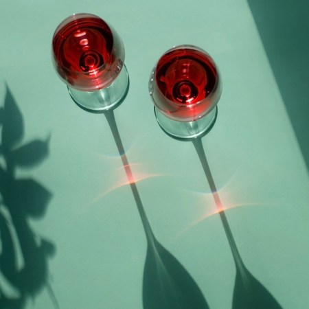 Two glasses of wine casting long shadows