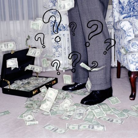 A man's feet with money on the floor