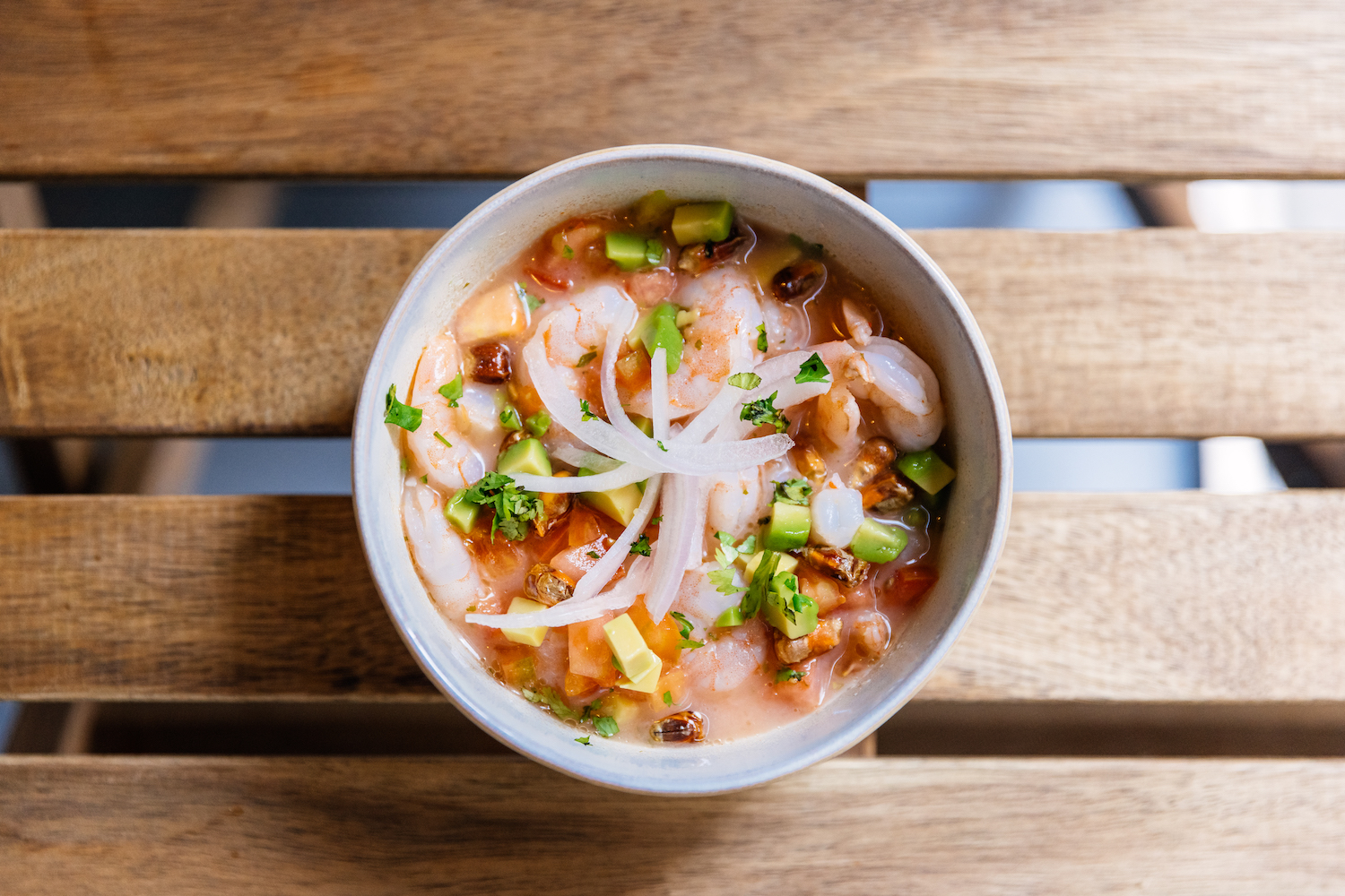 Shrimp ceviche in a bowl, directly above view