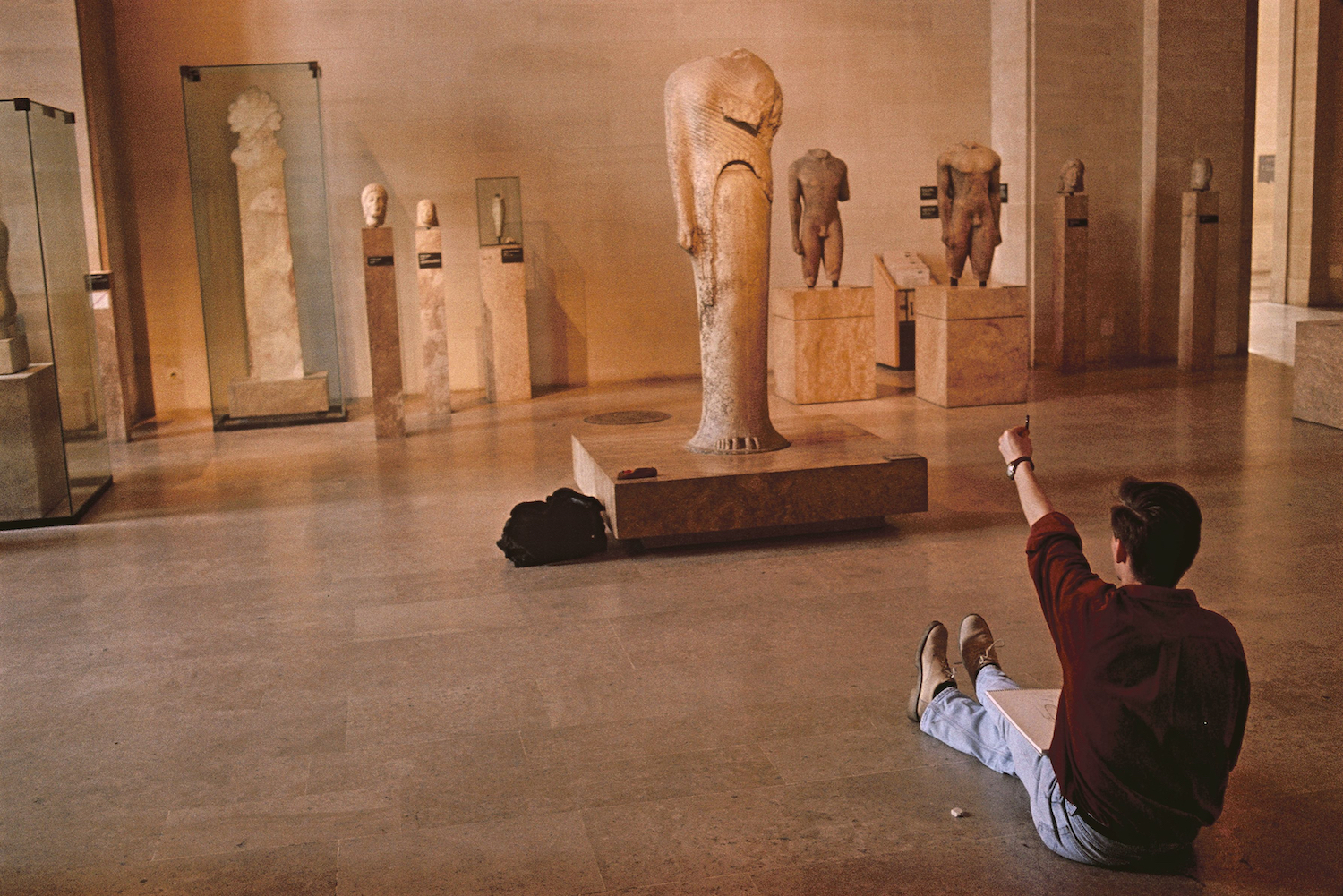 A man sitting in a museum.