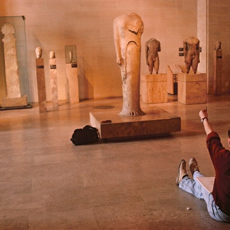 A man sitting in a museum.