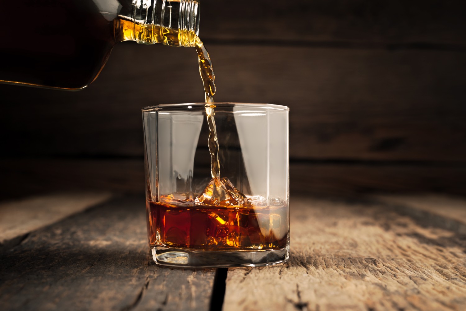 Glass of whiskey being poured