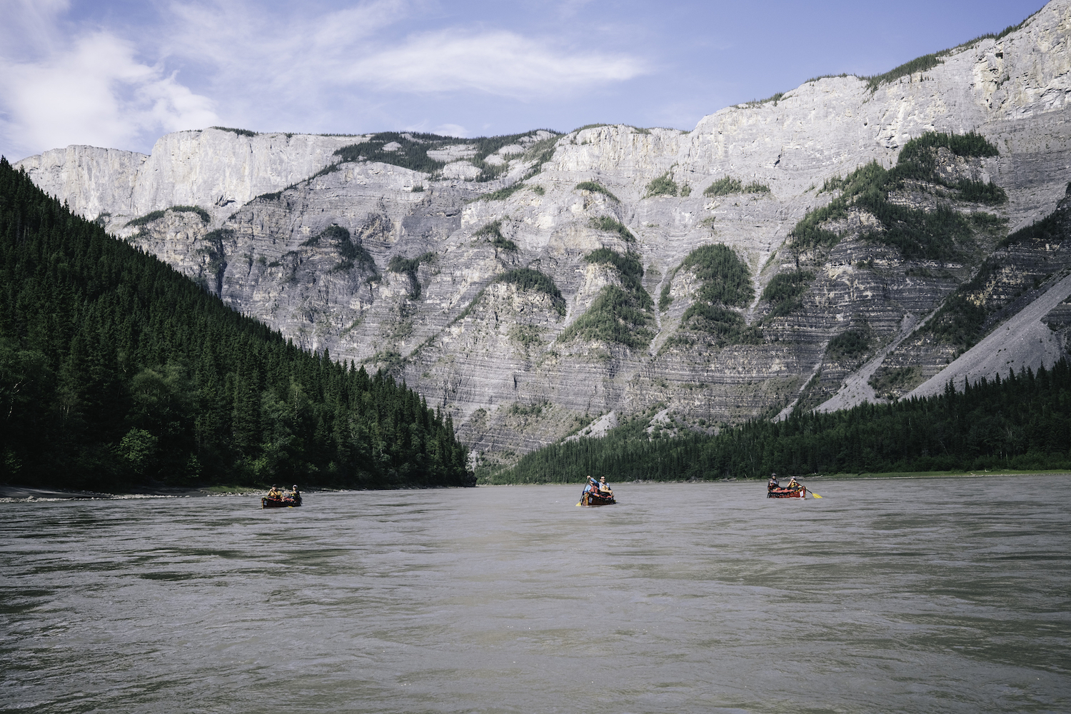 People canoeing down a river in Canada.
