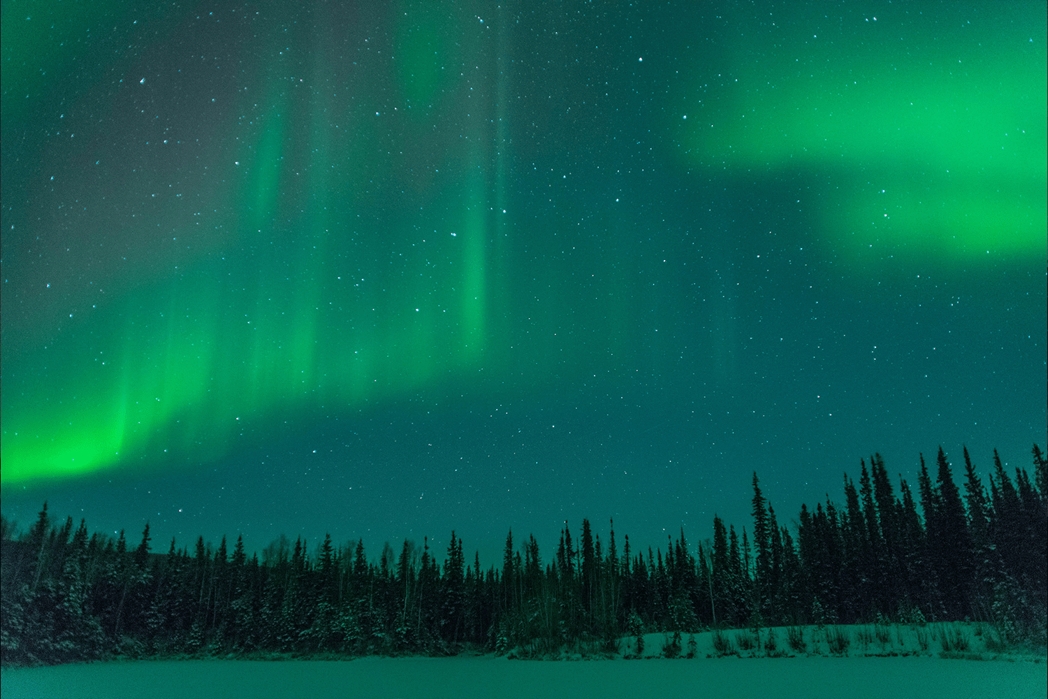 Green ribbons sweeping over Alaska