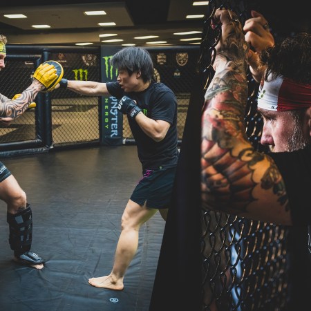 Left: An MMA coach wearing focus mitts and pads spars with a fighter in the cage. Right: A coach leans up against the cage watching his fighters.