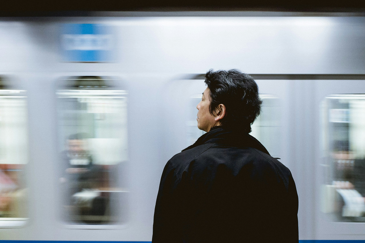 A man standing in front of a train.