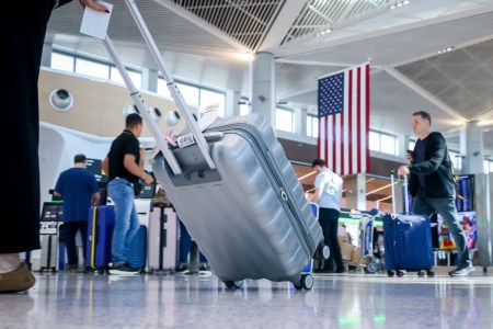 travelers with suitcases at Newark Airport