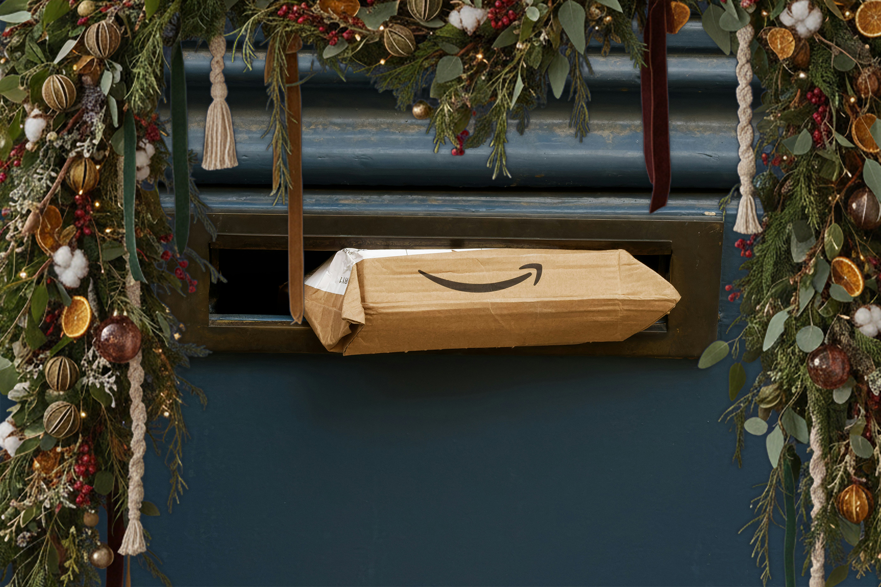 An Amazon package sticking out of a mail slot