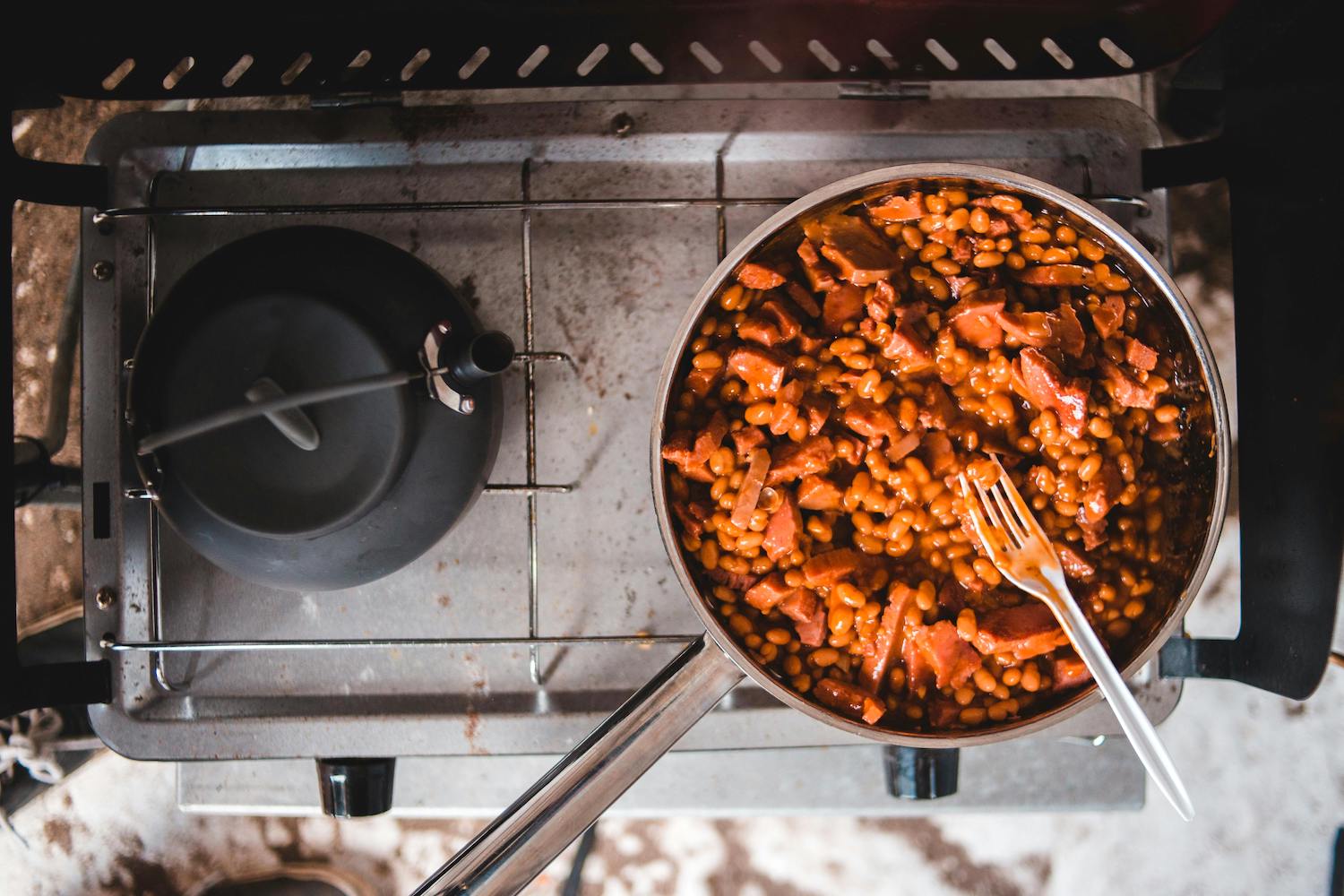 a pot of pork and beans on a stovetop