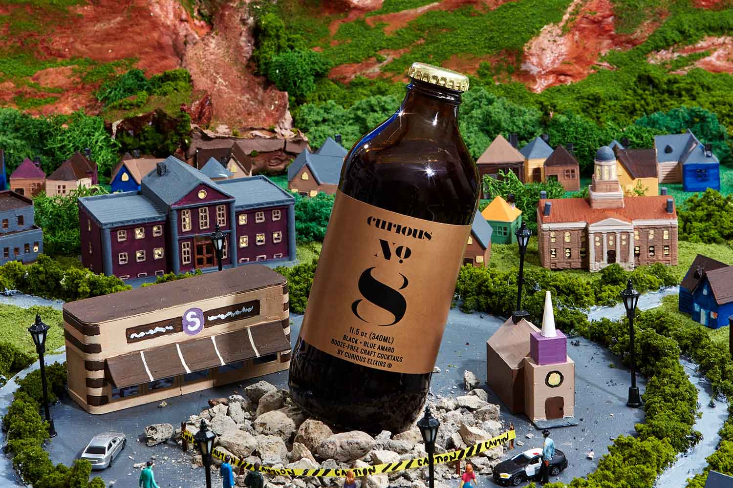 Curious Elixirs No. 8 bottle on top of a model fo a town
