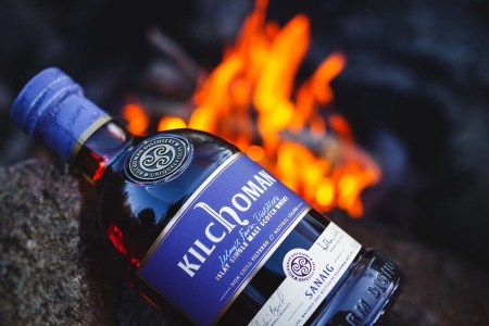Kilchoman Sanaig bottle in front of a fire