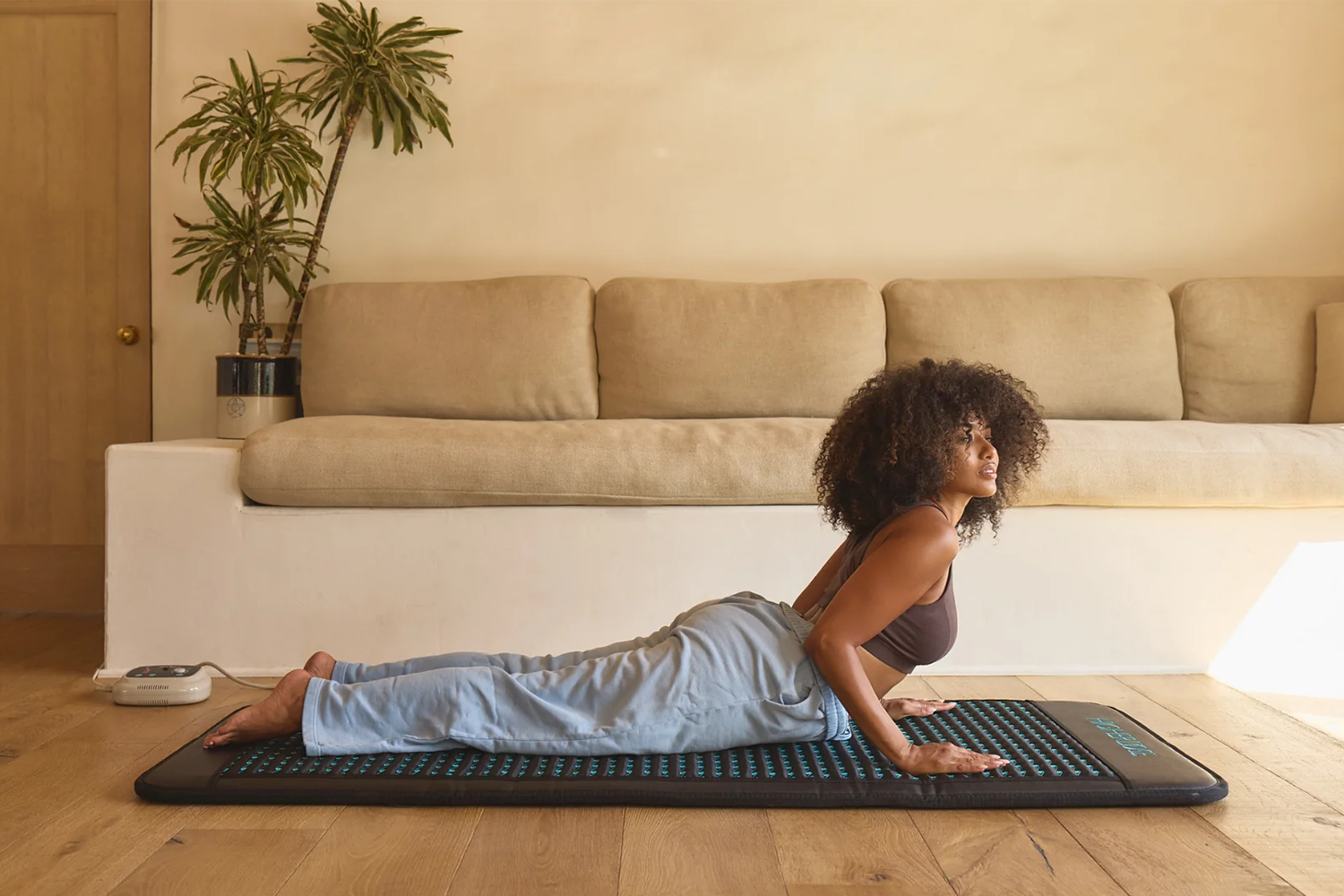 a woman on a yoga mat doing cobra yoga pose