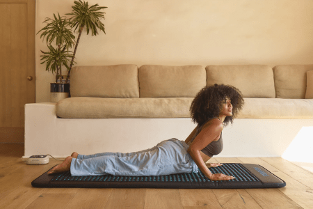 a woman on a yoga mat doing cobra yoga pose