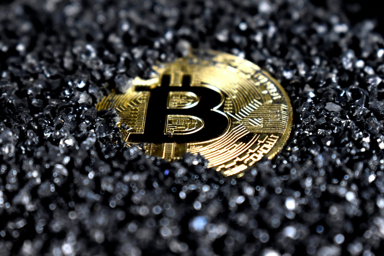 Bitcoin coin amidst gravel