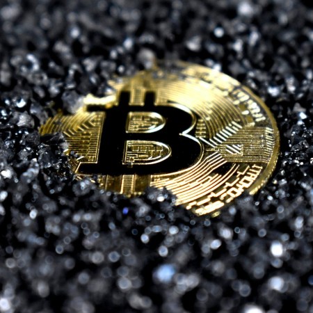 Bitcoin coin amidst gravel