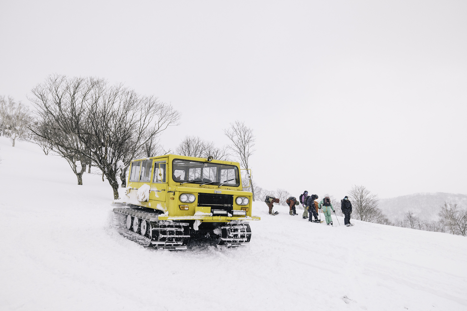 A yellow snowcat on a mountain in Hokkaido.