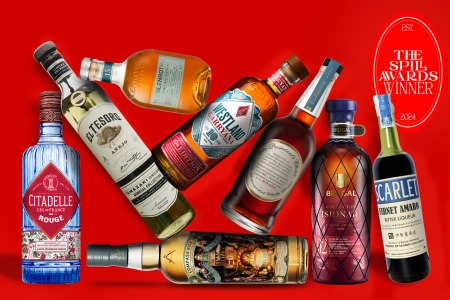 liquor bottles stacked on a red background