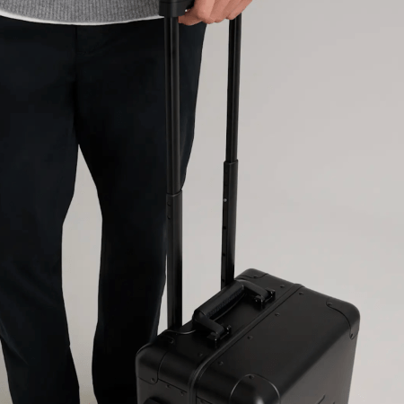 A model rolling a quince suitcase