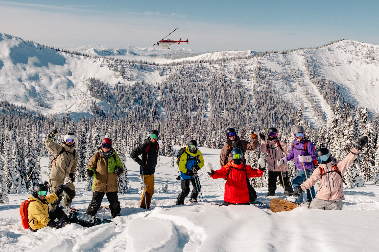 A group of skiers with the helicopter in the background.