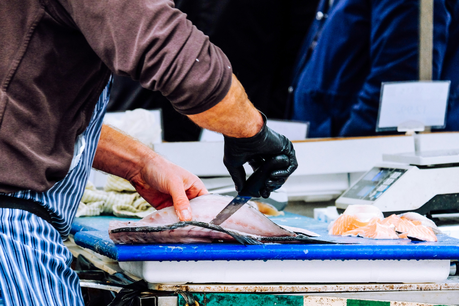 A man cutting a fish.