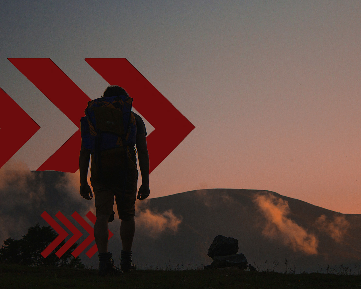 A man standing with a large rucking pack on his back.