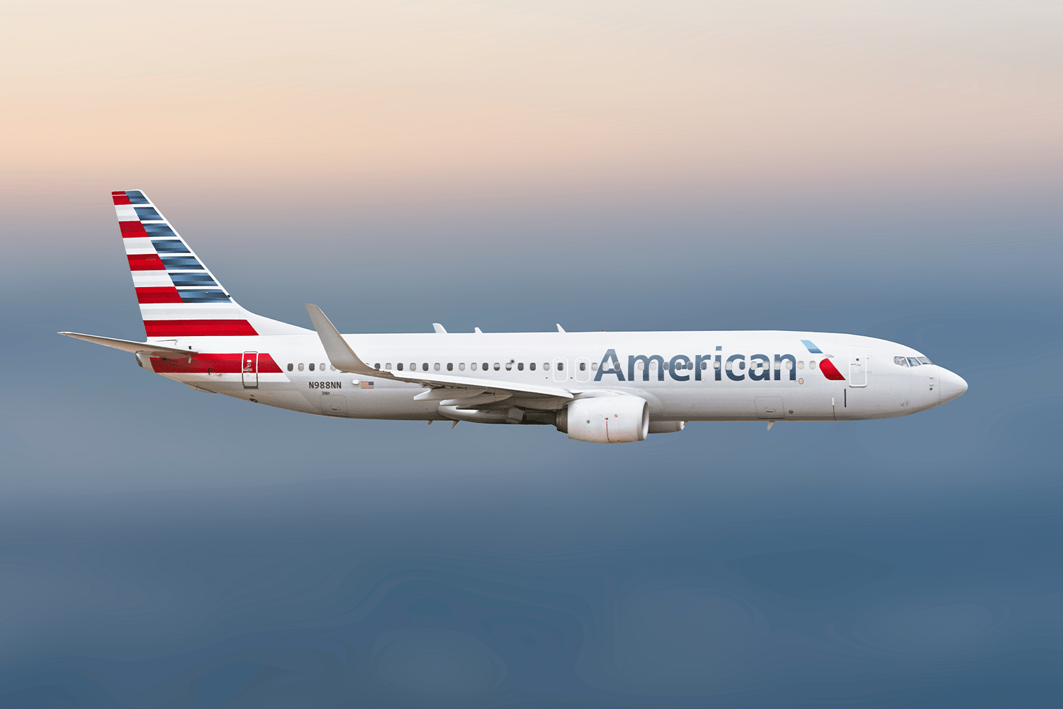 American Airlines plane flying in the sky above clouds, captured in midair.