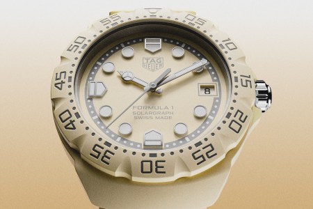 Five watches floating in the air in the colors pink, yellow, blue and green with a background that fades from white to blue