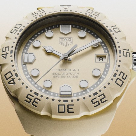 Five watches floating in the air in the colors pink, yellow, blue and green with a background that fades from white to blue