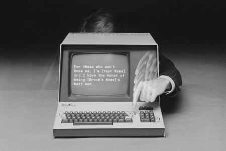 A man typing a speech on an old-fashioned computer, simulating the act of using AI to help him write