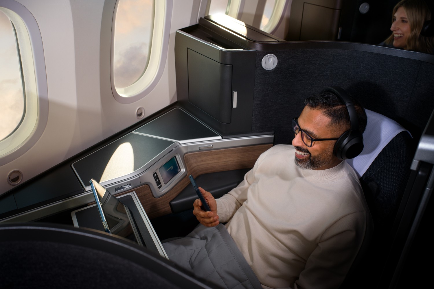 Man on plane watching his phone