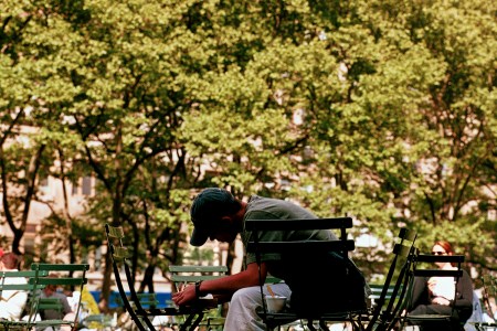 A man writing in the park