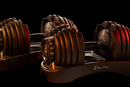 Lifestyle image of Bowflex dumbbells in low lighting