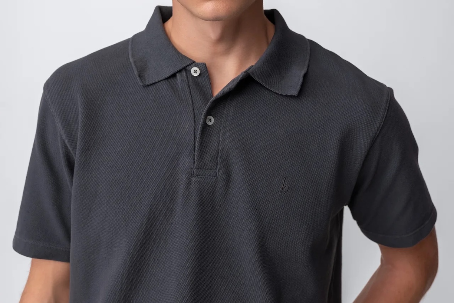 a model in a navy polo shirt