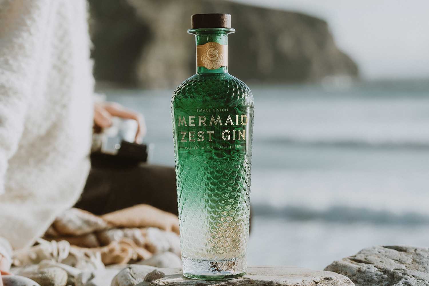 Mermaid Zest bottle on the shoreline