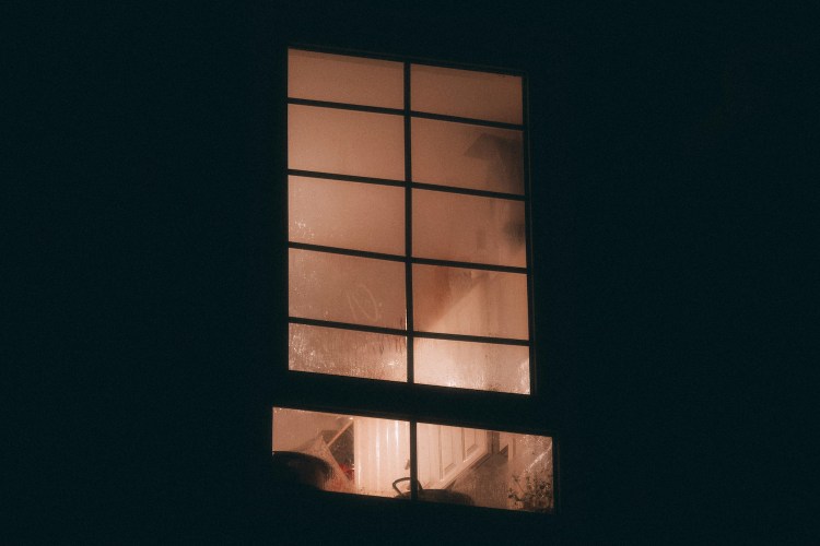 A bedroom window at night.