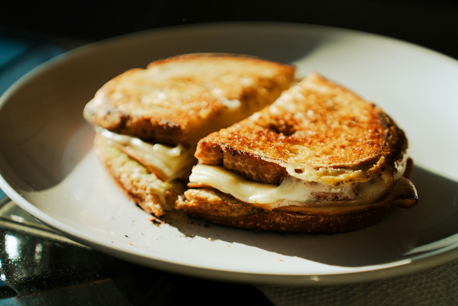 a toasted ham and cheese sandwich on a plate
