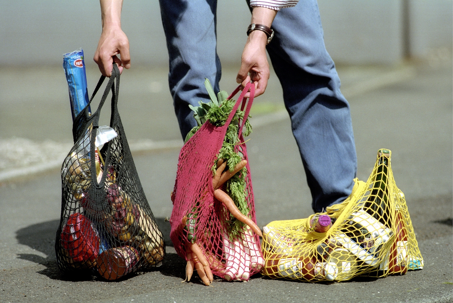 A man with three grocery bags.