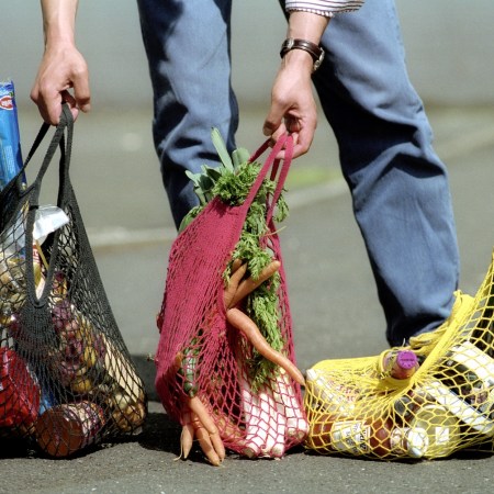A man with three grocery bags.