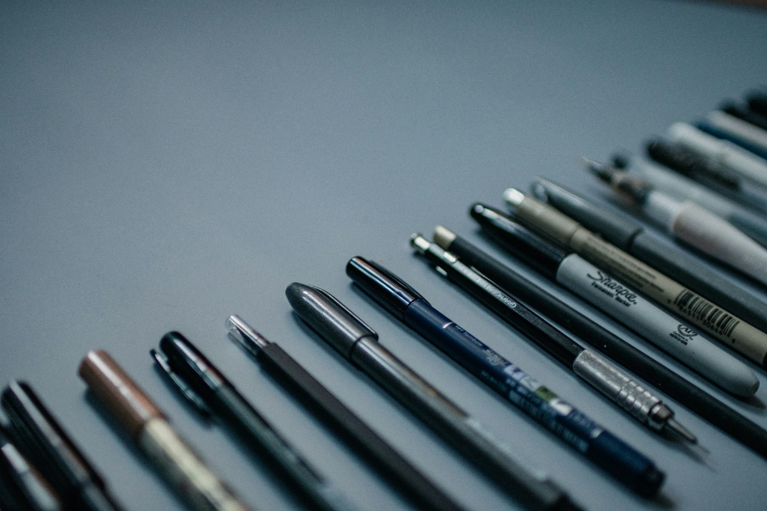 Pens against a gray background