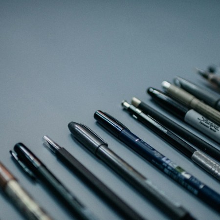 Pens against a gray background