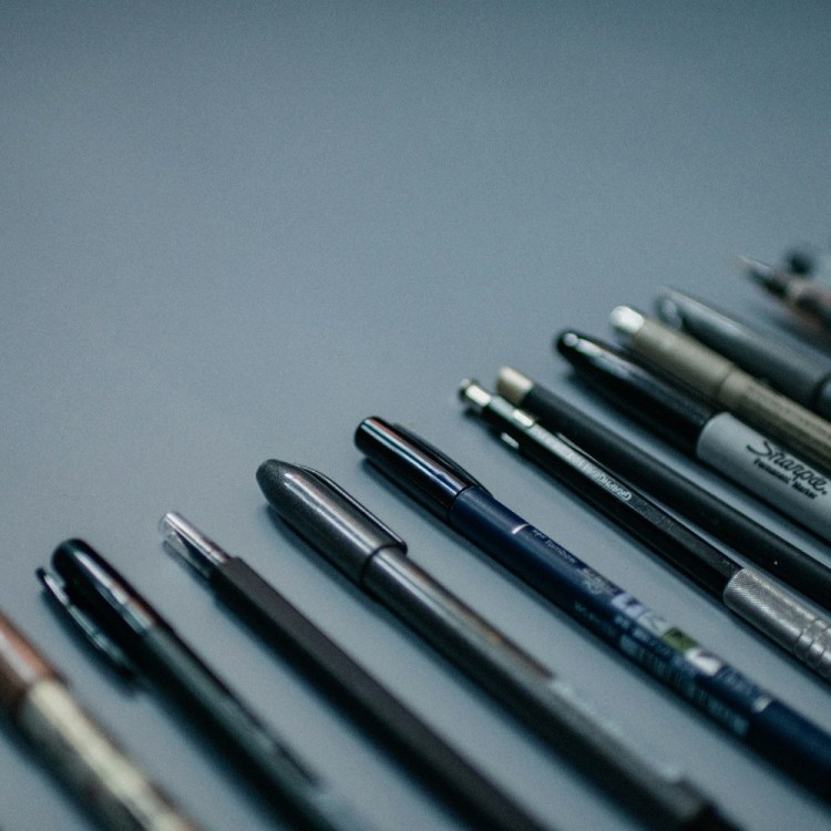 Pens against a gray background