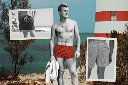 a vintage black and white photo of a man in red swim trunks on the beach