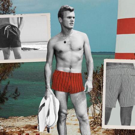 a vintage black and white photo of a man in red swim trunks on the beach