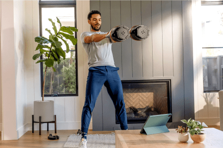lifestyle image from Bowflex of man working out with two kettlebells