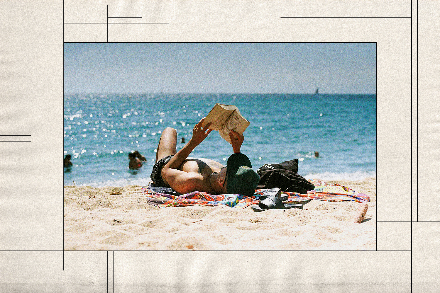 A man reading a book on the beach