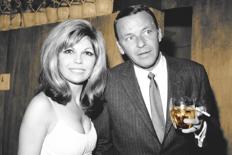 Frank Sinatra enjoys a cocktail at an event with his daughter singer Nancy Sinatra in circa 1967. (Photo by Earl Leaf/Michael Ochs Archives/Getty Images)