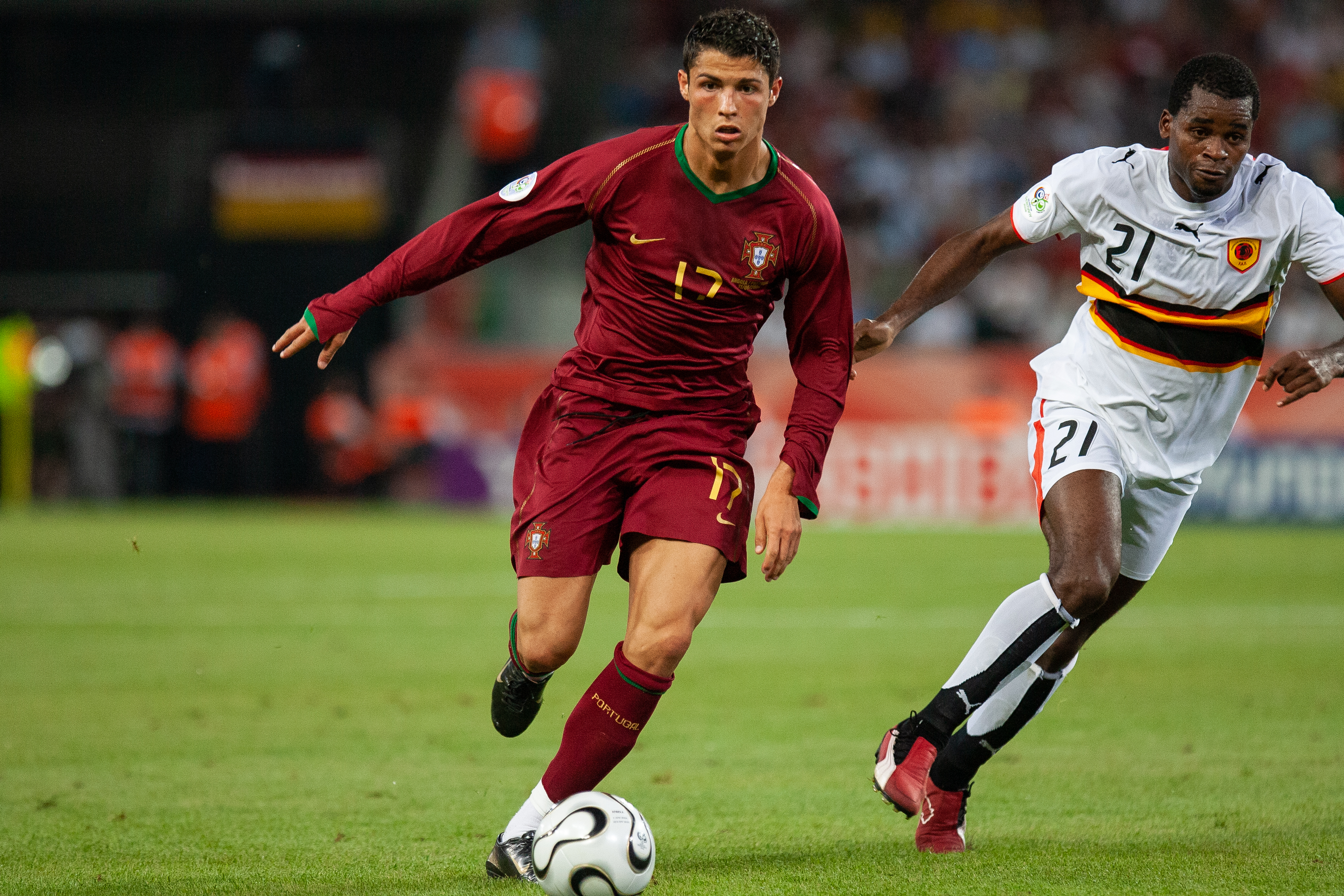 COLOGNE, GERMANY - JUNE 11: Cristiano Ronaldo of Portugal and Delgado of Angola in action during the FIFA World Cup Group D match between Portugal (1) and Angola (0) at the Rhein Energie Stadium on June 11th, 2006 in Cologne, Germany. (Photo by Simon Bruty/Anychance/Getty Images)