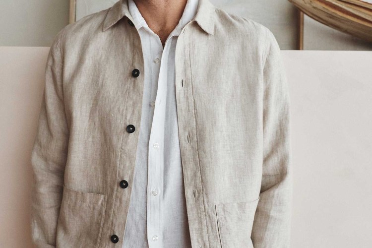 A model wearing a flax-colored Quince linen chore coat