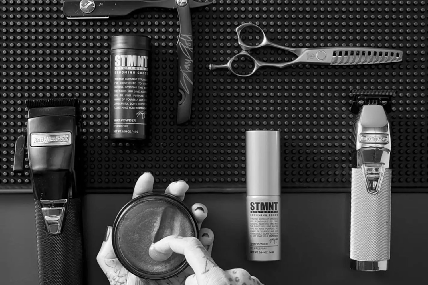 barber's hands using STMNT products